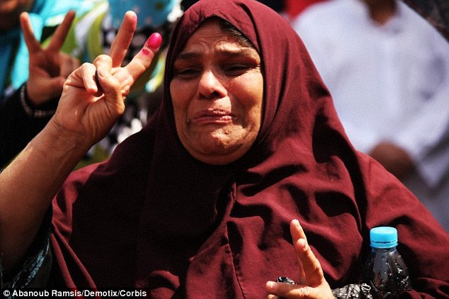 The study revealed that individuals who express negative reactions to positive news - shown here by a happy woman crying after voting in the first election since former President Mohamed Morsi was ousted in Egypt - were able to moderate intense emotions more quickly