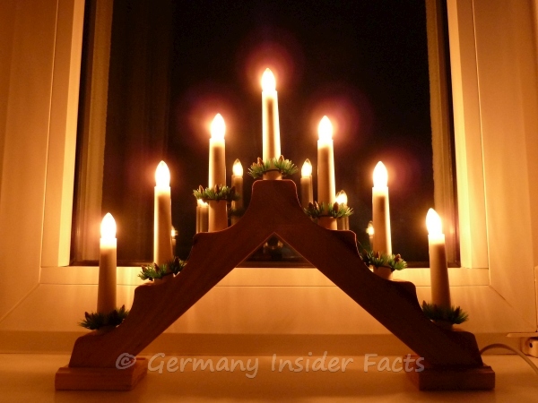 Photo of a simple candle arch on a window sill.