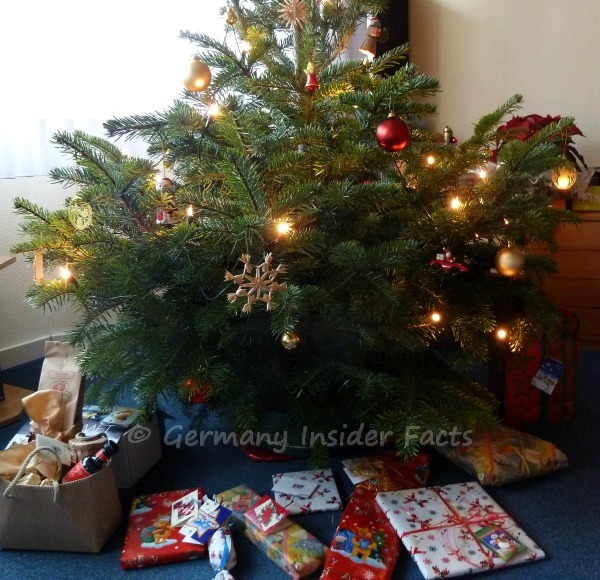 Photo of a decorated Christmas tree with presents on the floor and in a box