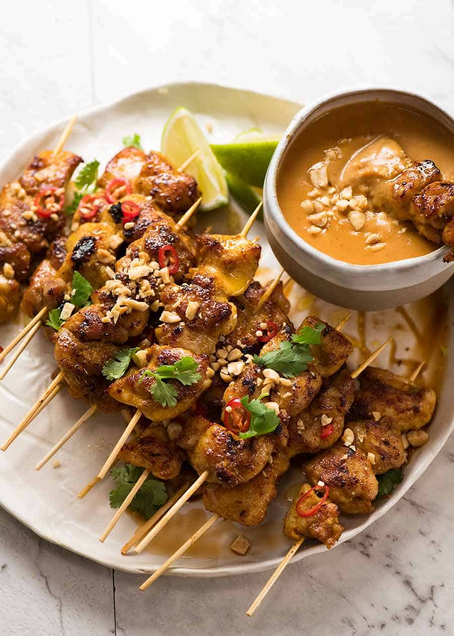 Chicken Satay skewers with Thai Peanut Sauce on a plate, ready to be eaten